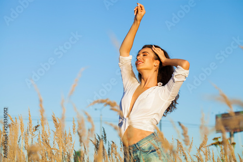 Beautiful young brunette woman in countryside