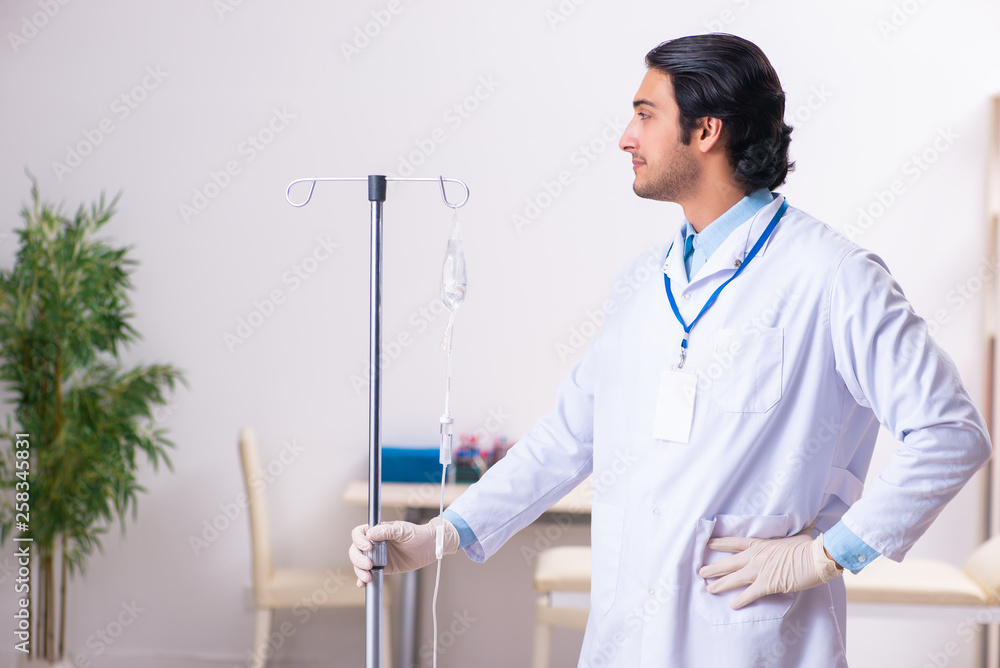 Young male doctor in blood transfusion concept Young male doctor in blood transfusion concept