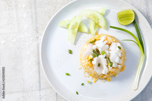 Fried rice with Squid on the wooden table from top view