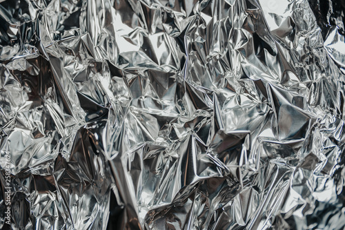 Silver rumpled foil. Gray background with texture