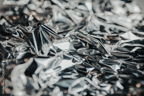 Silver rumpled foil. Gray background with texture