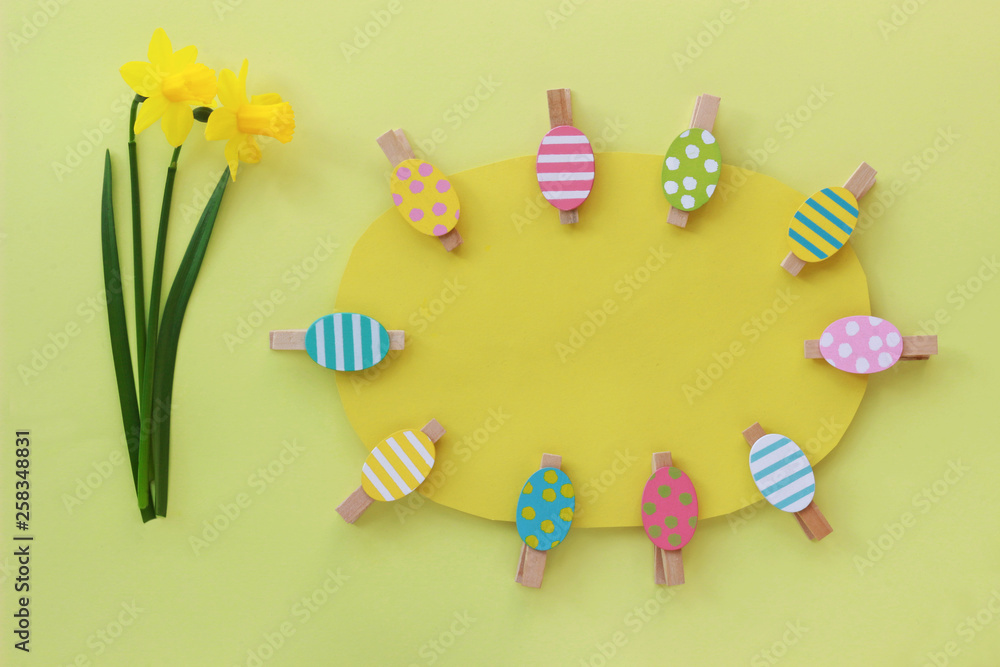 Easter background with colored eggs and two daffodils Easter background with colored eggs and two daffodils