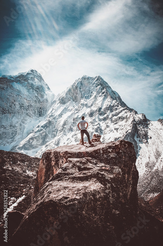 Triumphant hiker in front of ama dablam mountain