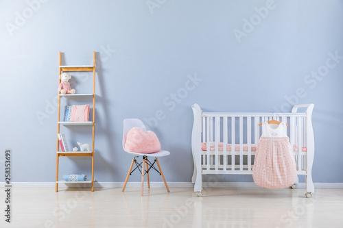 Shot of a crib in a modern white nursery room