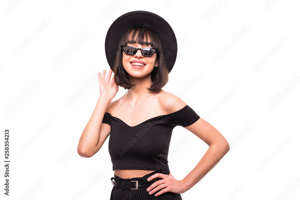 Fashion portrait pretty sweet young woman wearing a black hat sunglasses over white background Fashion portrait pretty sweet young woman wearing a black hat sunglasses over white background