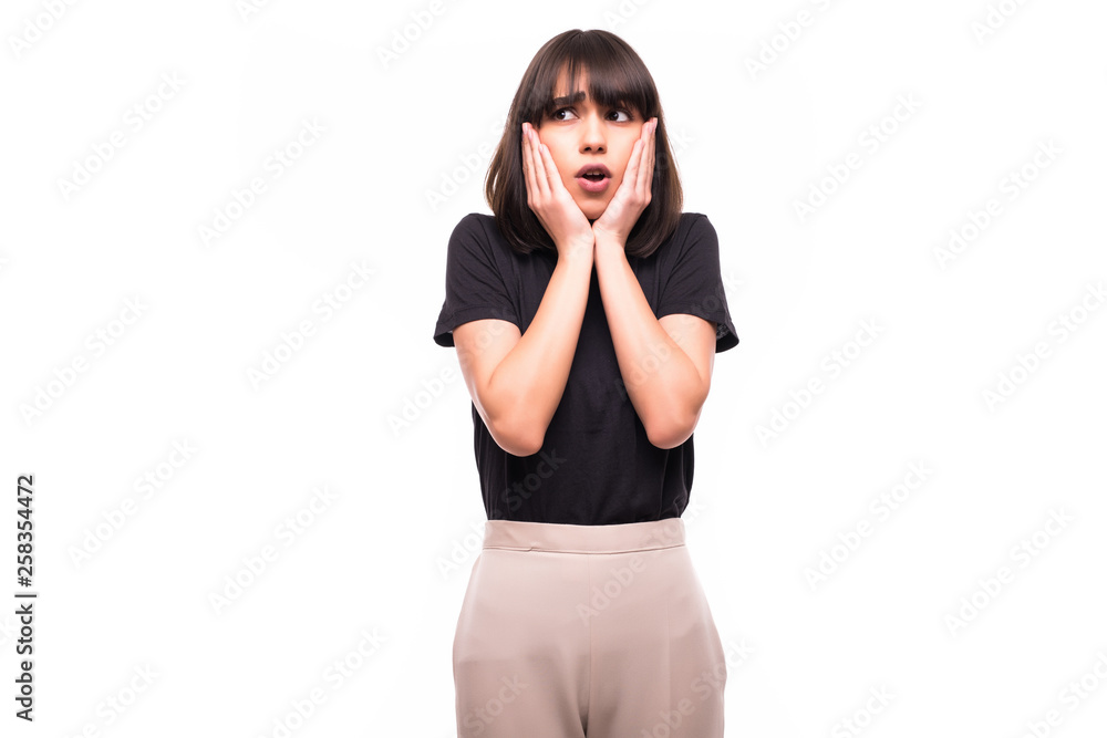 Portrait of shocked brunette woman with mouth open looking away isolated on a gray background Portrait of shocked brunette woman with mouth open looking away isolated on a gray background