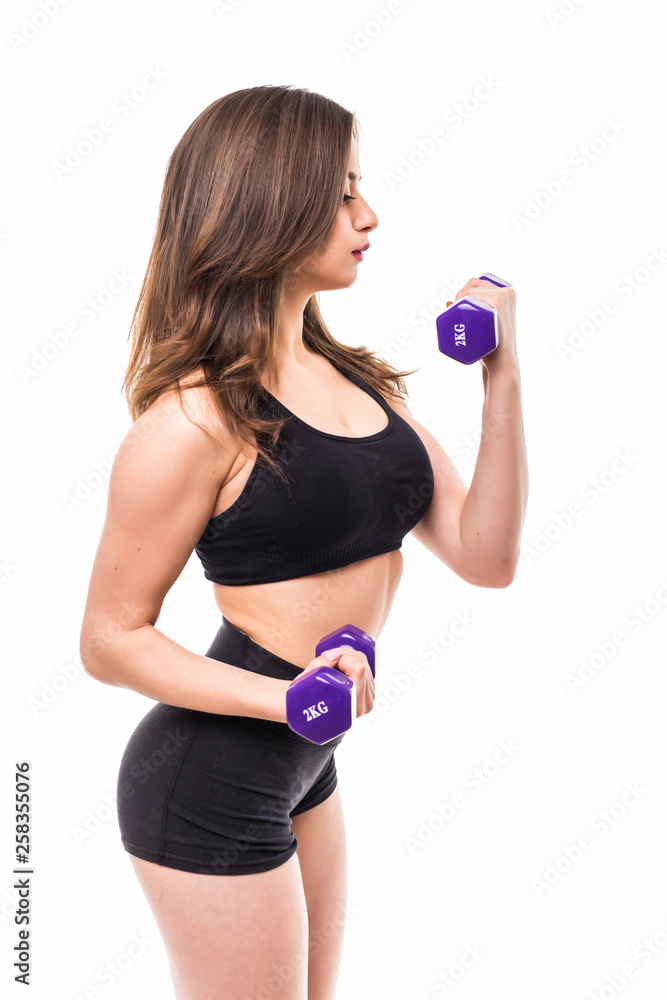 Sporty woman does the exercises with dumbbells on white background. Portrait of muscular woman in sportswear on white background. Strength and motivation. Sporty woman does the exercises with dumbbells on white background. Portrait of muscular woman in sportswear on white background. Strength and motivation.