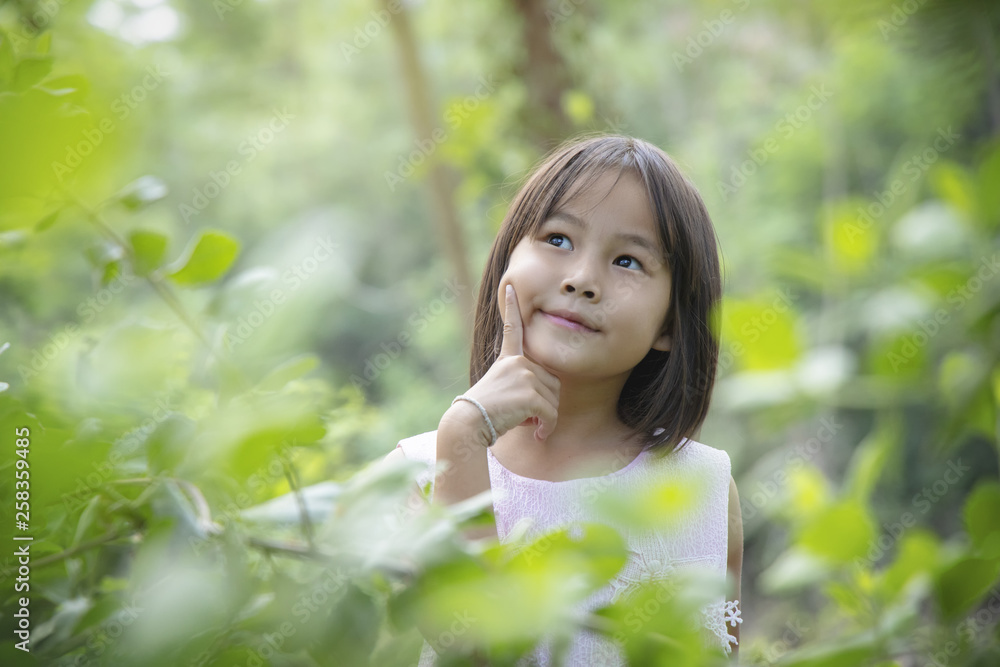 Portrait of a smiling little girl lying on green grass Portrait of a smiling little girl lying on green grass