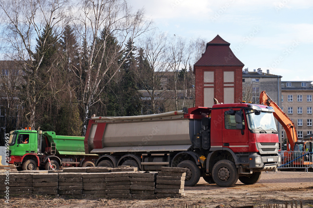 Trucks waiting for the earth to be loaded by the excavator. Construction site. Trucks waiting for the earth to be loaded by the excavator. Construction site.