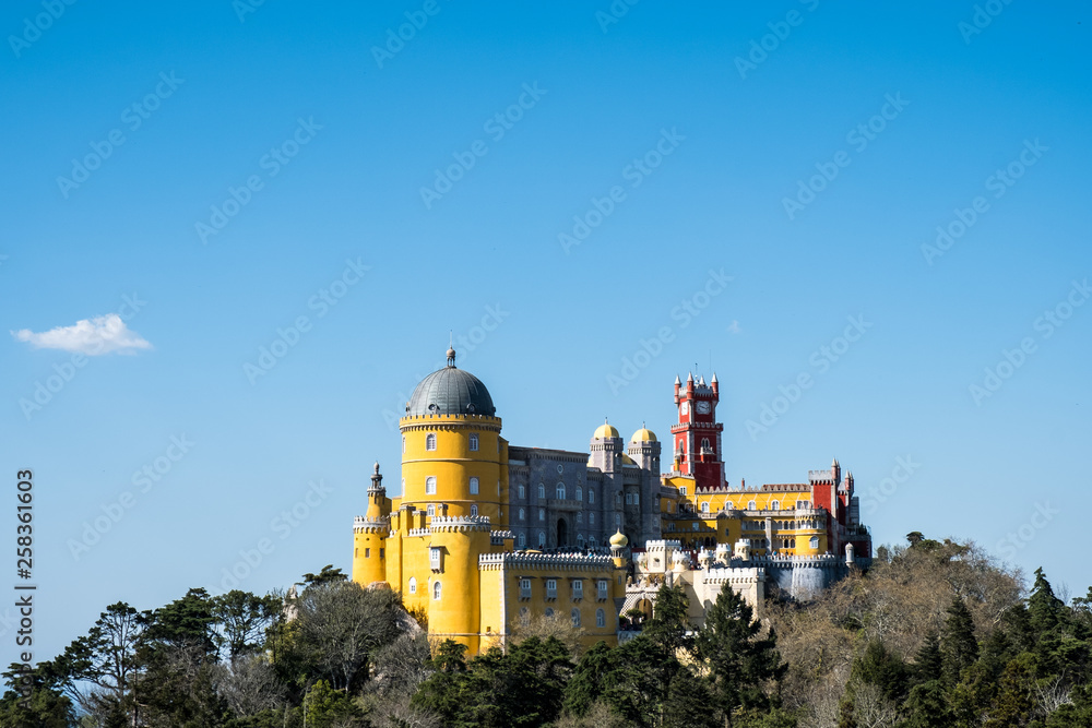Palace of Pena in Sintra. Lisbon, Portugal. Famous landmark. Summer morning landscape with blue sky. Palace of Pena in Sintra. Lisbon, Portugal. Famous landmark. Summer morning landscape with blue sky.