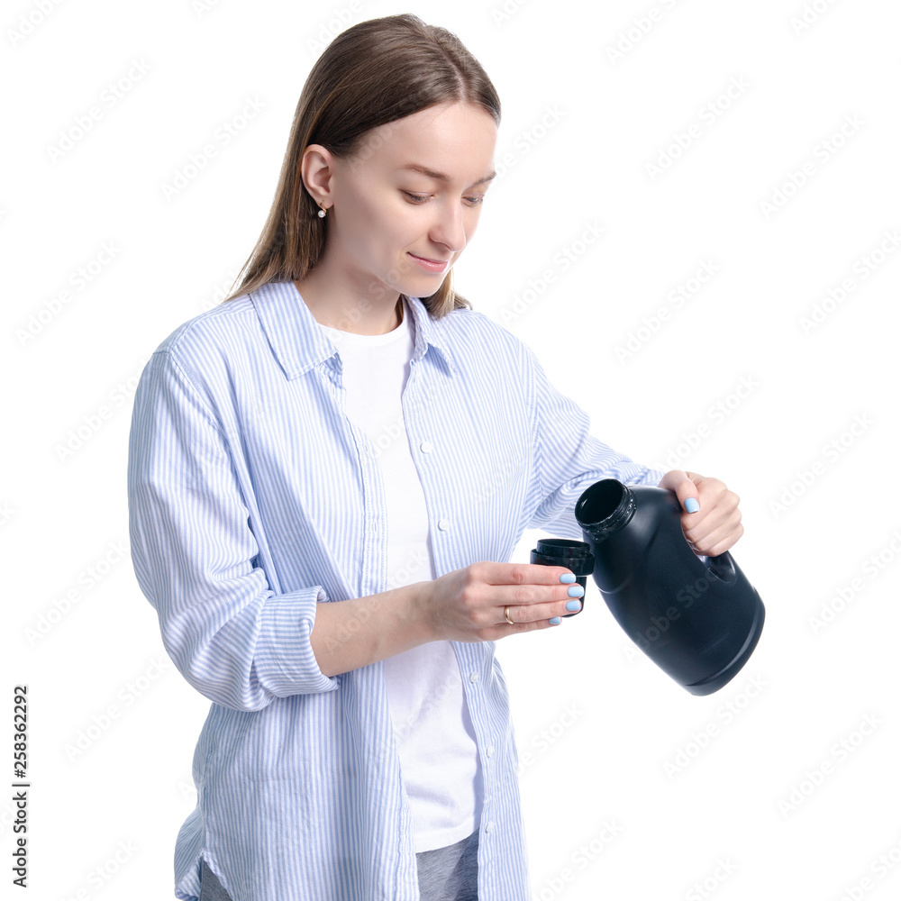 Woman housewife black bottle liquid laundry gel detergent in hand on white background isolation Woman housewife black bottle liquid laundry gel detergent in hand on white background isolation