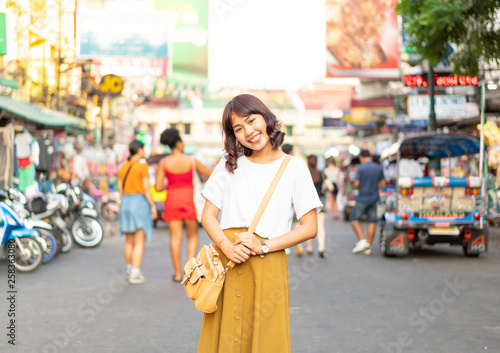 Happy and Beautiful Asian woman traveling at Khao Sarn Road, Thailand photo