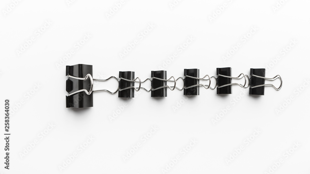One big office clip leading row of little ones One big office clip leading row of little ones