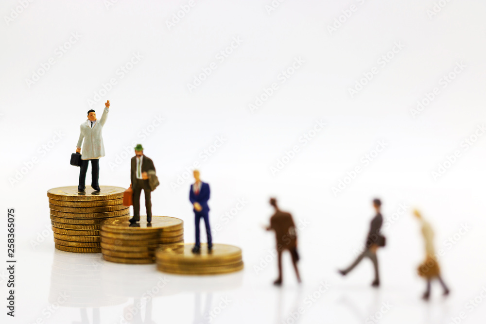 Miniature people: Businessmen standing on coins stack, Finance, investment and growth in business concept. Miniature people: Businessmen standing on coins stack, Finance, investment and growth in business concept.
