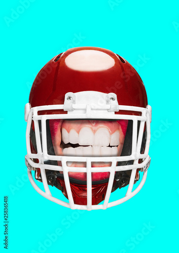 A tough safety. Beauty, feminism, protection of women's rights and american football theme. Head in red helmet on bright blue background. Modern art collage. Negative space. Contemporary pop design.