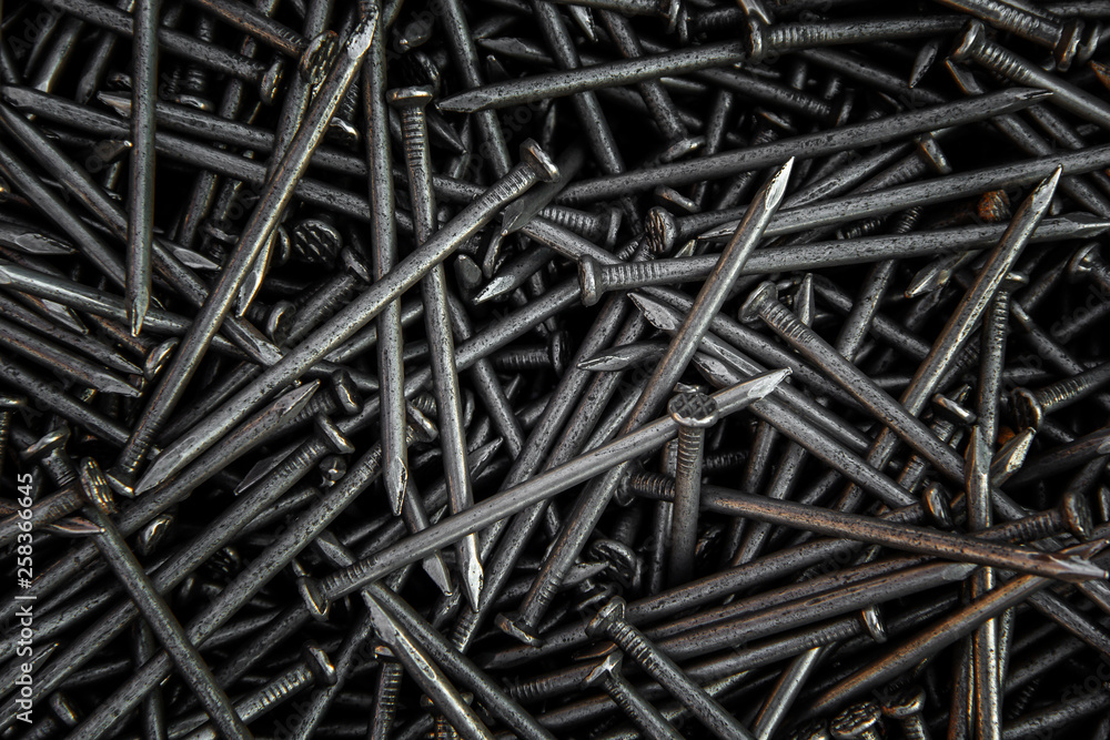 Detailed dark background and texture full frame of pile metal steel nails for construction of a carpenter. Detailed dark background and texture full frame of pile metal steel nails for construction of a carpenter.