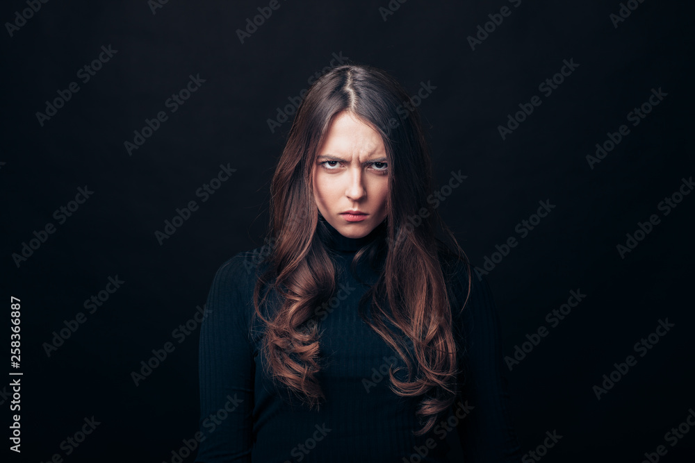 Portrait of angry upset woman isolated on black background
