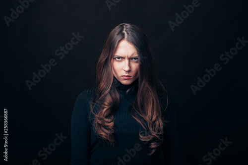 Portrait of angry upset woman isolated on black background