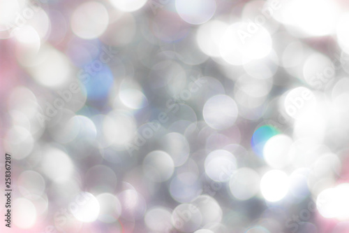 Bokeh abstract texture. Defocused light background with blurred bright white and pink lights.