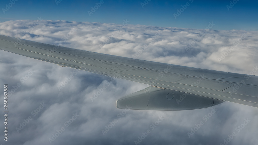 Obraz premium Traveling by air. Plane wing in flight. Beautiful sky and wonderful clouds