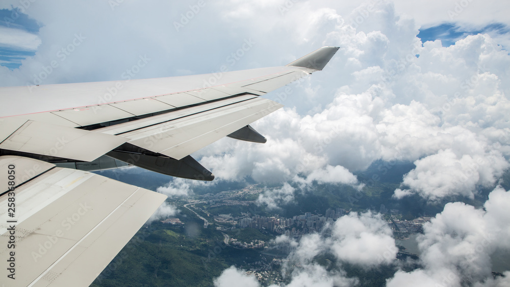 Aerial traveling. View through an plane window of Hong Kong city with clouds.. Aerial traveling. View through an plane window of Hong Kong city with clouds..