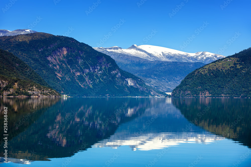 Beautiful Nature Norway natural landscape with fjord, boat and mountain.