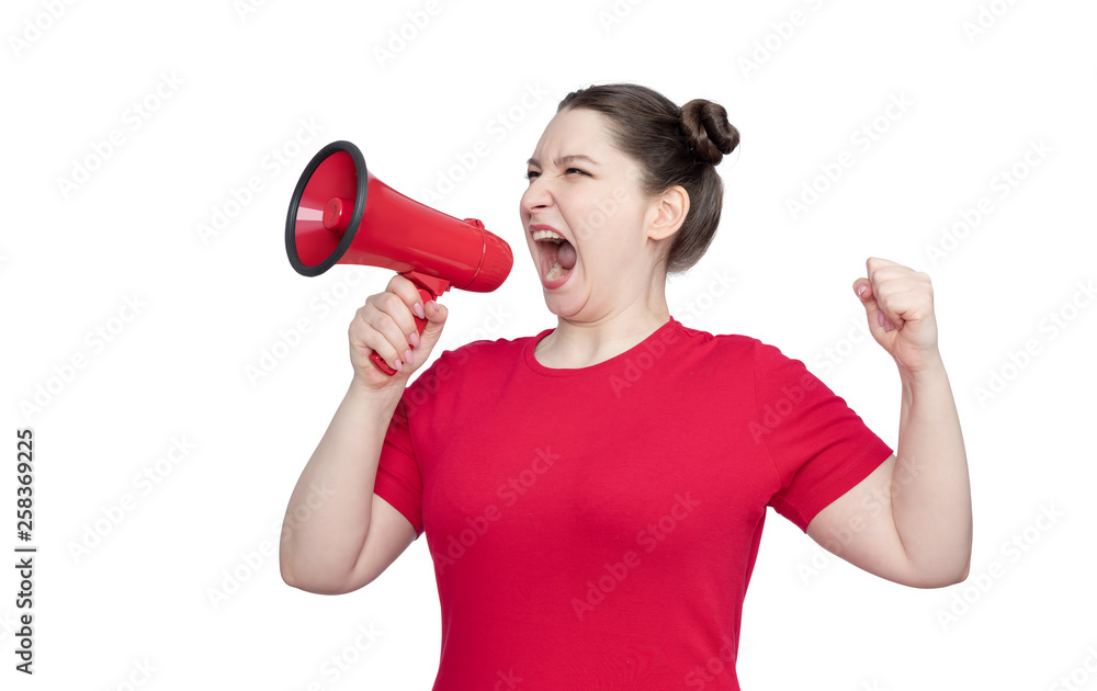 Naklejka premium Young girl activist in a red t-shirt screaming into a megaphone, isolated on white background