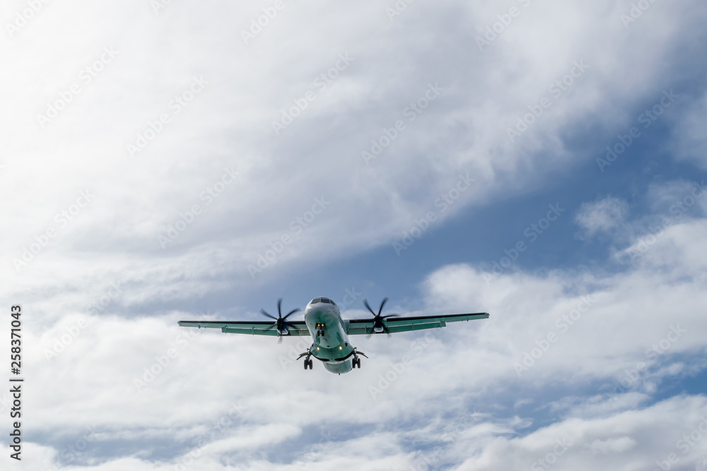 An ATR 72-600 turboprop-powered aircraft with wheels down preparing to land An ATR 72-600 turboprop-powered aircraft with wheels down preparing to land