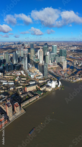 Fototapeta Naklejka Na Ścianę i Meble -  Aerial bird's eye panoramic photo taken by drone of iconic Canary Wharf skyscraper complex and business district, Isle of Dogs, London, United Kingdom
