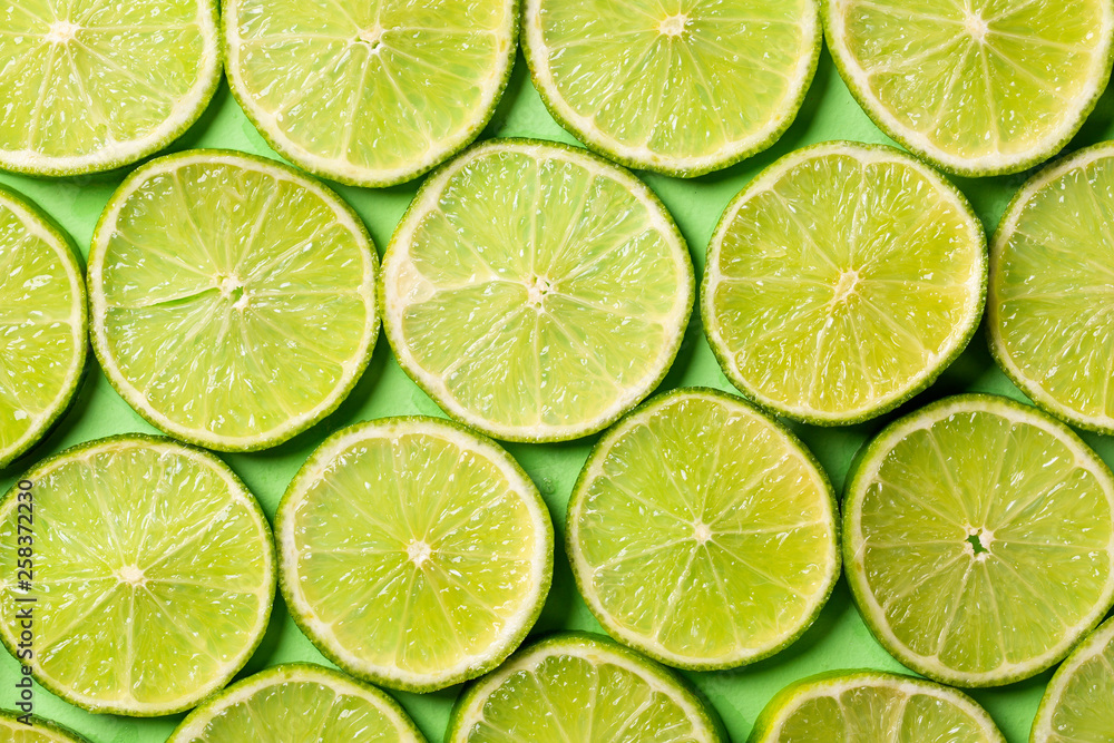 A slices of fresh juicy green lemons. Texture background, pattern