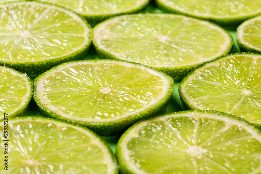 A slices of fresh juicy green lemons. Texture background, pattern A slices of fresh juicy green lemons. Texture background, pattern