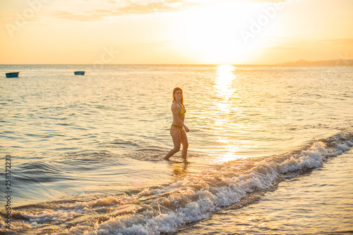 Hot girl in sexy bikini on sunset. Hot young beautiful girl posing in bikini on beach in sunset