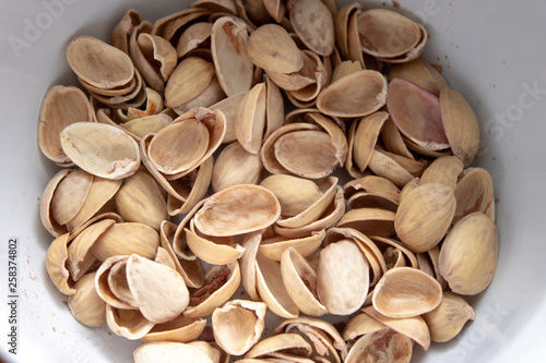 peel from delicious pistachios in a plate.