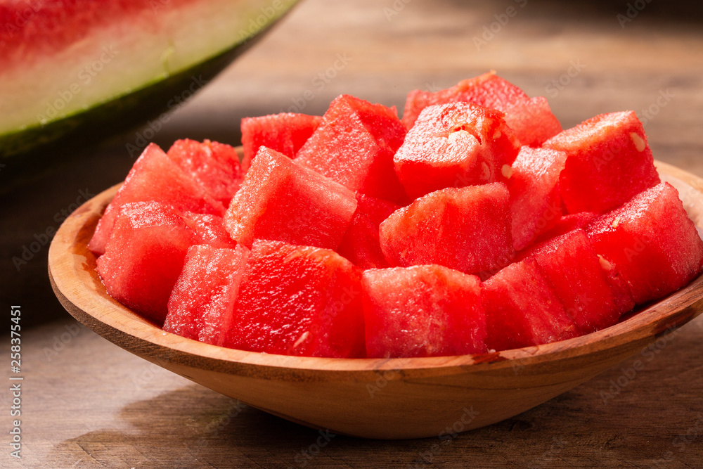 fresh watermelon cut into cubes on wooden bowl fresh watermelon cut into cubes on wooden bowl
