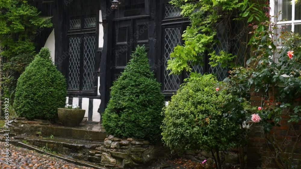 English, historic, tudor style house with diamond pattern leaded glass windows in rainy weather. Rye, West Susex, England. English, historic, tudor style house with diamond pattern leaded glass windows in rainy weather. Rye, West Susex, England.