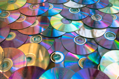 Background on the wall with old damaged discs cd.