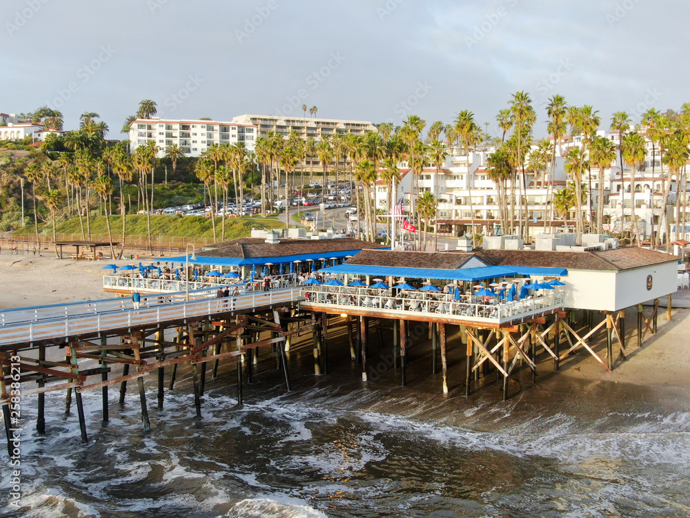 Aerial view of San Clemente Pier with beach and coastline before sunset time . San Clemente city in Orange County, California, USA. Travel destination in the South West Coast. Famous beach for surfer.