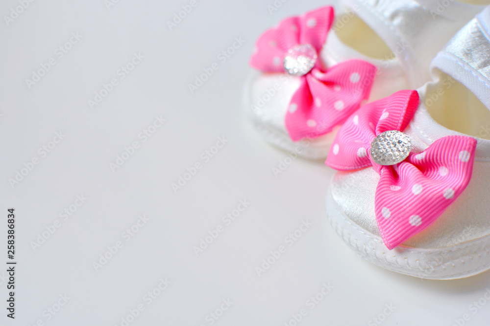 Baby girl booties with pink bow, copy space Baby girl booties with pink bow, copy space