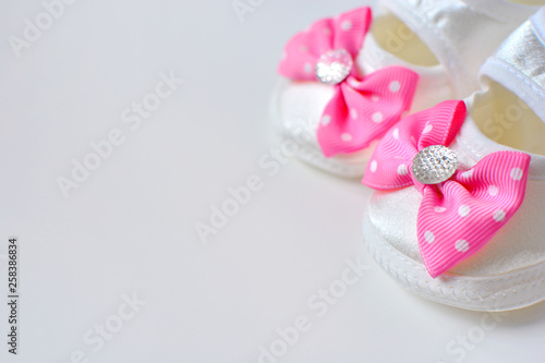 Baby girl booties with pink bow, copy space