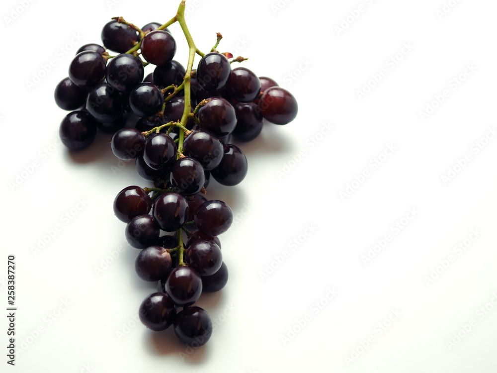 Black grapes on a white background