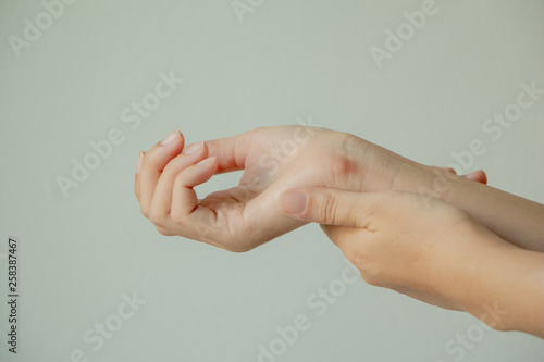 Female arms holding her painful wrist caused by prolonged work on the computer, laptop.Carpal tunnel syndrome, arthritis,healthcare concept.