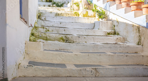 Greece, Kea island. Ioulis city narrow street with stairs and traditional buildings