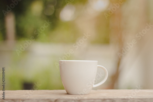 Cup of hot coffee in the morning green bokeh background.copy space.