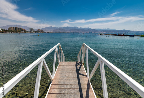 View on the Red Sea from swimming footpath at central public beach of Eilat - famous resort and recreational city in Israel and Middle East