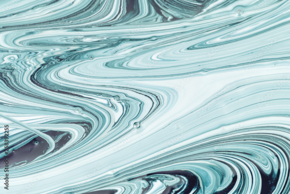 Empty abstract background for layouts. The process of mixing dark turquoise and white paint close-up. Empty abstract background for layouts. The process of mixing dark turquoise and white paint close-up.