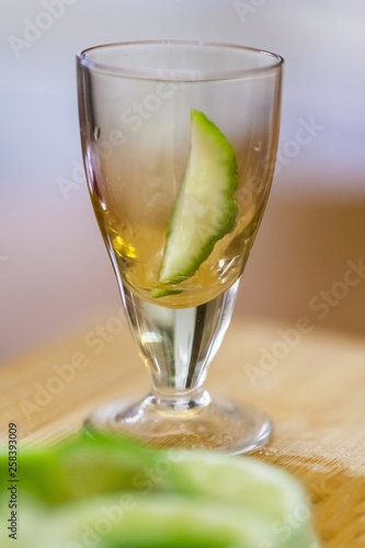 stack with lime slice on wooden table, close up, blurry background