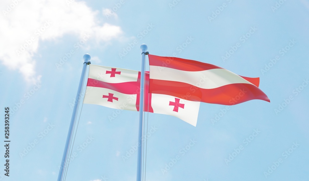 Georgia and Austria, two flags waving against blue sky. 3d image