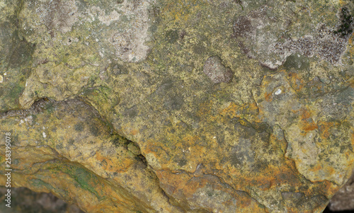 Multicolor Rock texture and surface background. Cracked and weathered natural stone background.