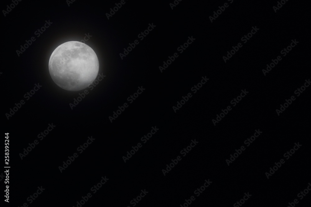 Full moon on black sky background - blank with space for text Full moon on black sky background - blank with space for text