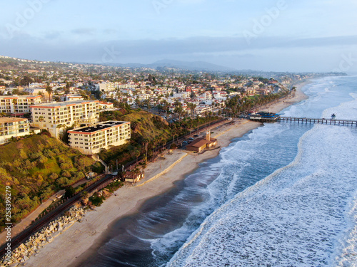 Aerial view of San Clemente Pier with beach and coastline before sunset time . San Clemente city in Orange County, California, USA. Travel destination in the South West Coast. Famous beach for surfer.